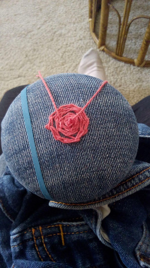 Jean leg being mended on a darning mushroom